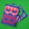 Coffret KIMOMÖ avec trois planches de masques colorés à découper pour enfants.
