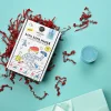 Boîte Fabrique de bombes de bain Paris Nailmatic avec confettis rouges et pot plastique bleu.