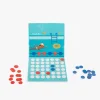 Jeu magnétique 4 à la suite avec plateau bleu illustré piscine, pions rouges et bleus.