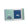 Livre de naissance Puce et Pilou ouvert, pages pastel avec illustrations d’animaux et enveloppe bleue.