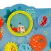 Panneau d'activités Les aventures de Paulie, poissons colorés, formes tournantes, bulles multicolores, fond bleu marine.
