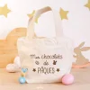 Petit cabas en coton bio écru avec texte brun "Mes chocolats de Pâques" et motifs œuf et lapin.