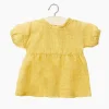 Robe Faustine plumetis moutarde pour poupées Babies - Minikane